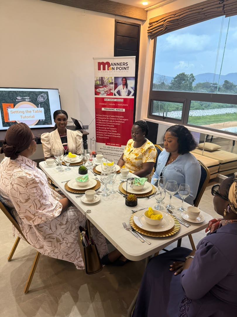 Ladies seated at a formally laid dining table during an etiquette session at the 2025 retreat.