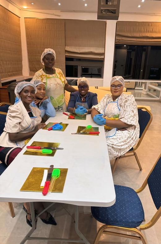 Guests at work around the cake decoration table.