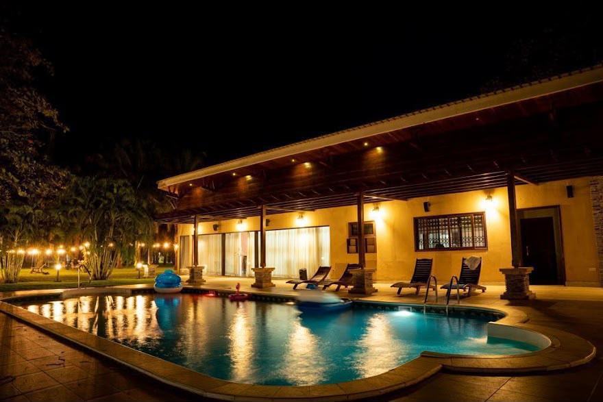 The resort terrace and pool lit up in the evening.